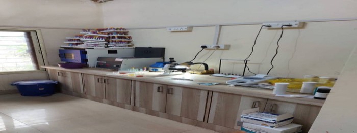 Laboratory work bench with microscope, sample racks and testing equipment